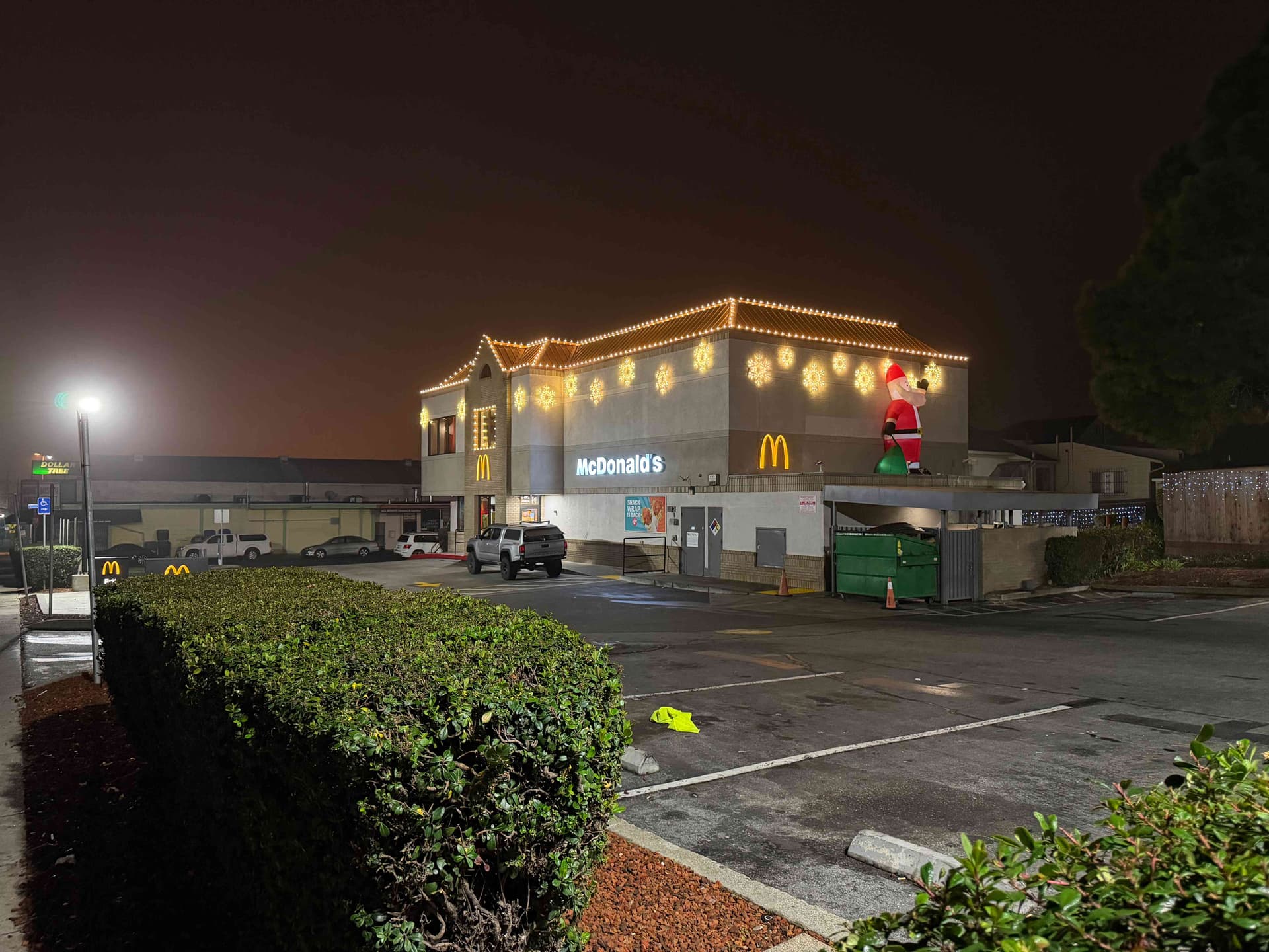Two-story commercial building with warm white C9 roofline and snowflake motifs